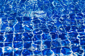 Blue color water in swimming pool rippled