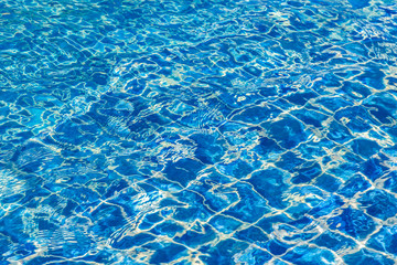 Blue color water in swimming pool rippled