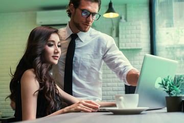 Fototapeta premium Businessman and businesswoman casual meeting together. Asian woman using laptop present and sharing business idea. concept of business, education, finance and thinking.