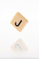 Alphabet J word block with white background.