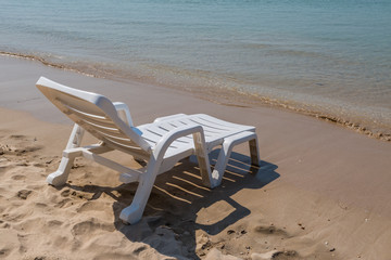 Fototapeta na wymiar Beach chair at sunny coast at the beach