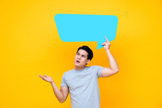 Curious Asian man with empty speech bubble
