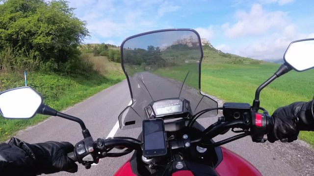 Motorcyclist Riding on the Road near Spiss Castle. Spissky Hrad. Slovakia