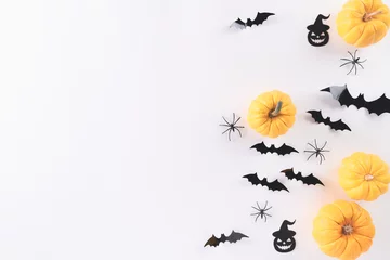 Fototapeten Top view of Halloween crafts, yellow pumpkin, ghost, bat and spider on white background with copy space for text. halloween concept. © Siam