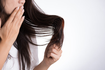 Healthy concept. Woman show her brush with damaged long loss hair and looking at her hair.