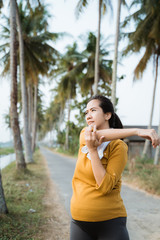 pregnant woman exercising outdoor. maternity workout of asian woman