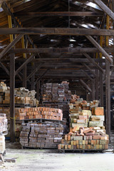stacks of bricks in abandoned factory warehouse