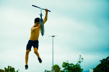 Skater boy training in city skate park outdoor . Young trendy man performing skills and tricks with...