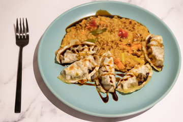 spicy vegetable risotto with vegan dumplings and soy sauce