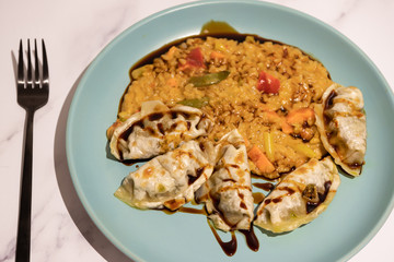 spicy vegetable risotto with vegan dumplings and soy sauce