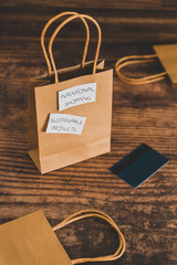 ethically sourced and eco-friendly items concept, shopping bag with sustainable products and intentional purchase labels