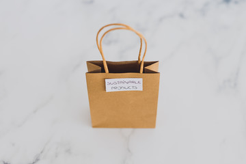 ethically sourced and eco-friendly items concept, shopping bag with sustainable products and intentional purchase labels