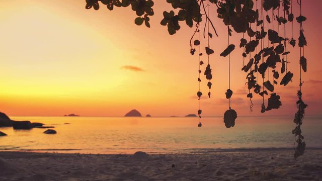 4K UHD Cinemagraph of a mobile gently swinging in the wind at a beach on Perhentian Island, Malaysia by sunset.