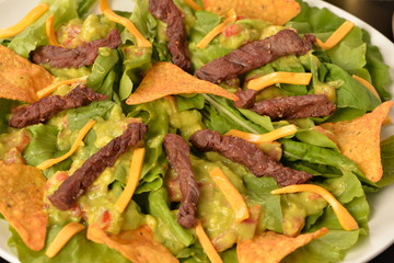 salad, filet mignon and tortilla chips