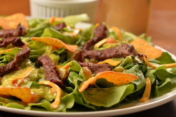 salad, filet mignon and tortilla chips