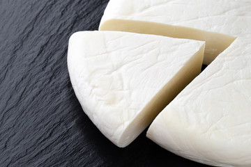 Cheese on a slate surface. Piece of cheese close-up.
