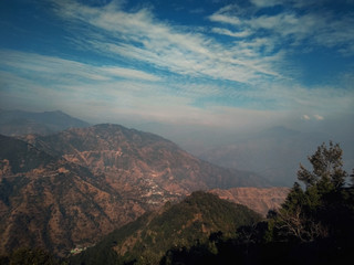 Clouds hovering over mountains