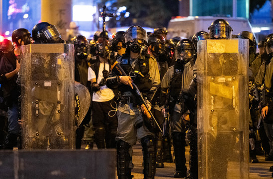 Hong Kong Policeman With Gun Ready To Fire At Protestors