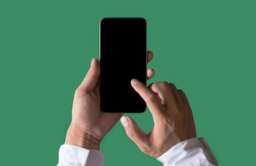 Hand holding white mobile phone with blank white screen in Sea green background.