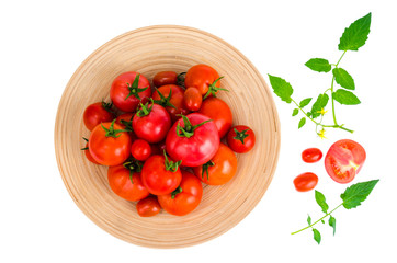 Wooden dish with different ripe tomatoes on white background.