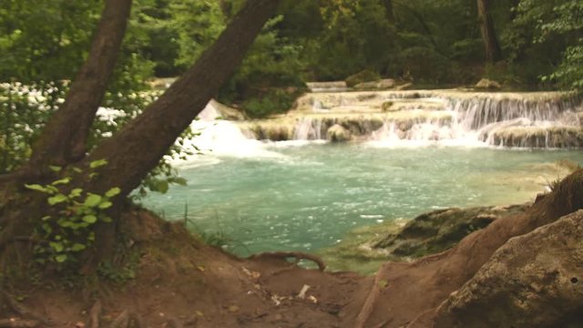 man photographs the beautiful Colle Val d'Elsa waterfall with his smart phone