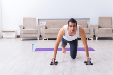 Young man training and exercising at home