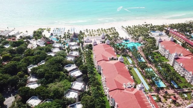 Top view of beautiful beach. Aerial drone shot of turquoise sea water at the beach. Luxury tropical resort with white sand. Aerial view