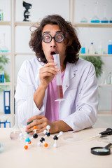Funny male chemist working in the lab