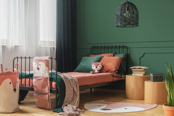 Black fancy chandelier in fashionable teenager bedroom with single bed