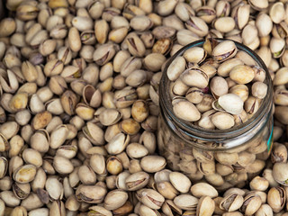 Pistachio nuts in a glass jar for sale. Pistachios close up.