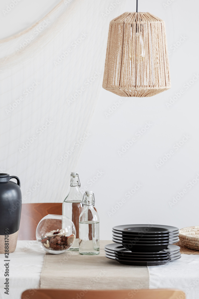 Wall mural close-up of designed beige lamp above table