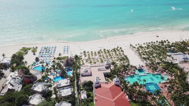 Top view of beautiful beach. Aerial drone shot of turquoise sea water at the beach. Luxury tropical resort with white sand. Aerial view
