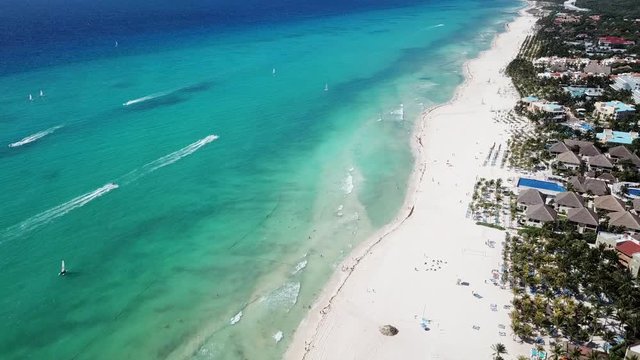 Top view of beautiful beach. Aerial drone shot of turquoise sea water at the beach. Luxury tropical resort with white sand. Aerial view