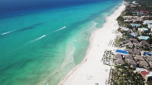 Top view of beautiful beach. Aerial drone shot of turquoise sea water at the beach. Luxury tropical resort with white sand. Aerial view