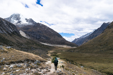 Fototapeta na wymiar Unidentified backpacker walking through the mountains of Huascaran National Park, on the way to Lake 69, Peru
