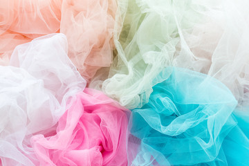 Bright and colorful tulle cloth closeup. Fabric for tutu skirt. Glamour fashionable clothes for woman and little girls - obrazy, fototapety, plakaty