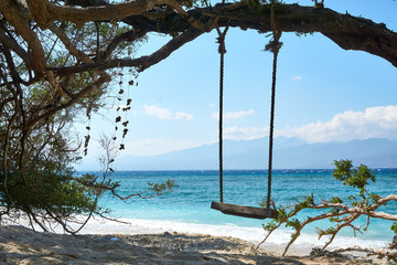 TRAWANGAN, INDONESIA - AUGUST.15.2019: Swing at the beach on Gili trawangan.