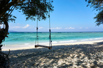 TRAWANGAN, INDONESIA - AUGUST.15.2019: Swing at the beach on Gili trawangan.