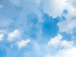 Obraz premium Big cloud floating in blue sky with copy space. Water droplets and ice crystals gathered together into clumps. Floating in the azure atmosphere
