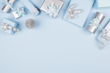 Christmas background for your design and text - soft pastel blue and silver gift boxes with bows,...