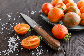 red tomatoes with dill on a wooden board. Home cooking