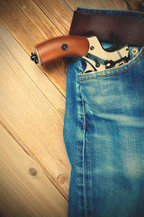 revolver nagant in the pocket of old blue jeans