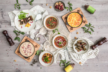 Food Table Celebration Delicious Party Meal Concept. A lot of food on the wooden table: meat, vegetables, desserts, garnishes.  Foodset from Georgian dishes. Caucasian food