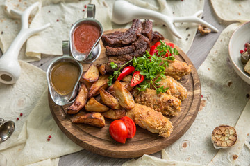Food Table Celebration Delicious Party Meal Concept. A lot of food on the wooden table: meat, vegetables, desserts, garnishes.  Foodset from Georgian dishes. Caucasian food