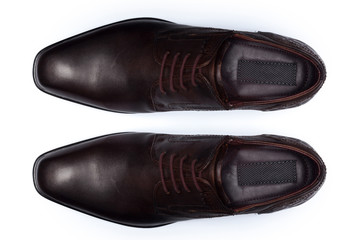 Classic male leather shoes isolated on a white, top view.