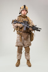 Portrait of a young American US Marine Corps soldier over grey background