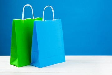 Arrangement of shopping bags on blue background