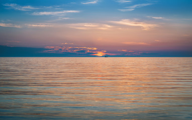 Fototapeta na wymiar Beautiful sunset scenery with ships silhouette and amazing cloudy sky