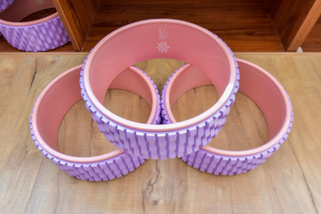 All kinds of Yoga props are on the wooden floor of the yoga studio. Conveyor belts, mats and cushion blocks are in the yoga center. The concept of health activities
