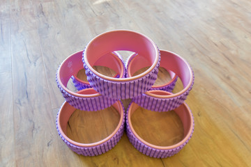 All kinds of Yoga props are on the wooden floor of the yoga studio. Conveyor belts, mats and cushion blocks are in the yoga center. The concept of health activities
